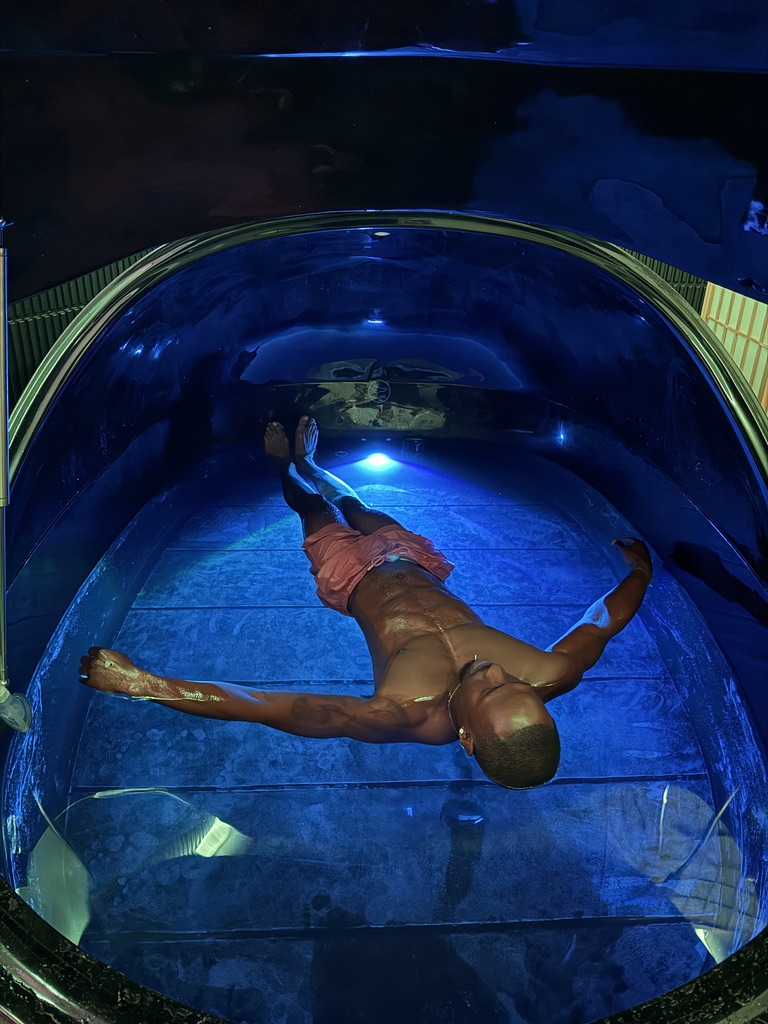 A single person floating in the XL Dream Pod with plenty of space around them